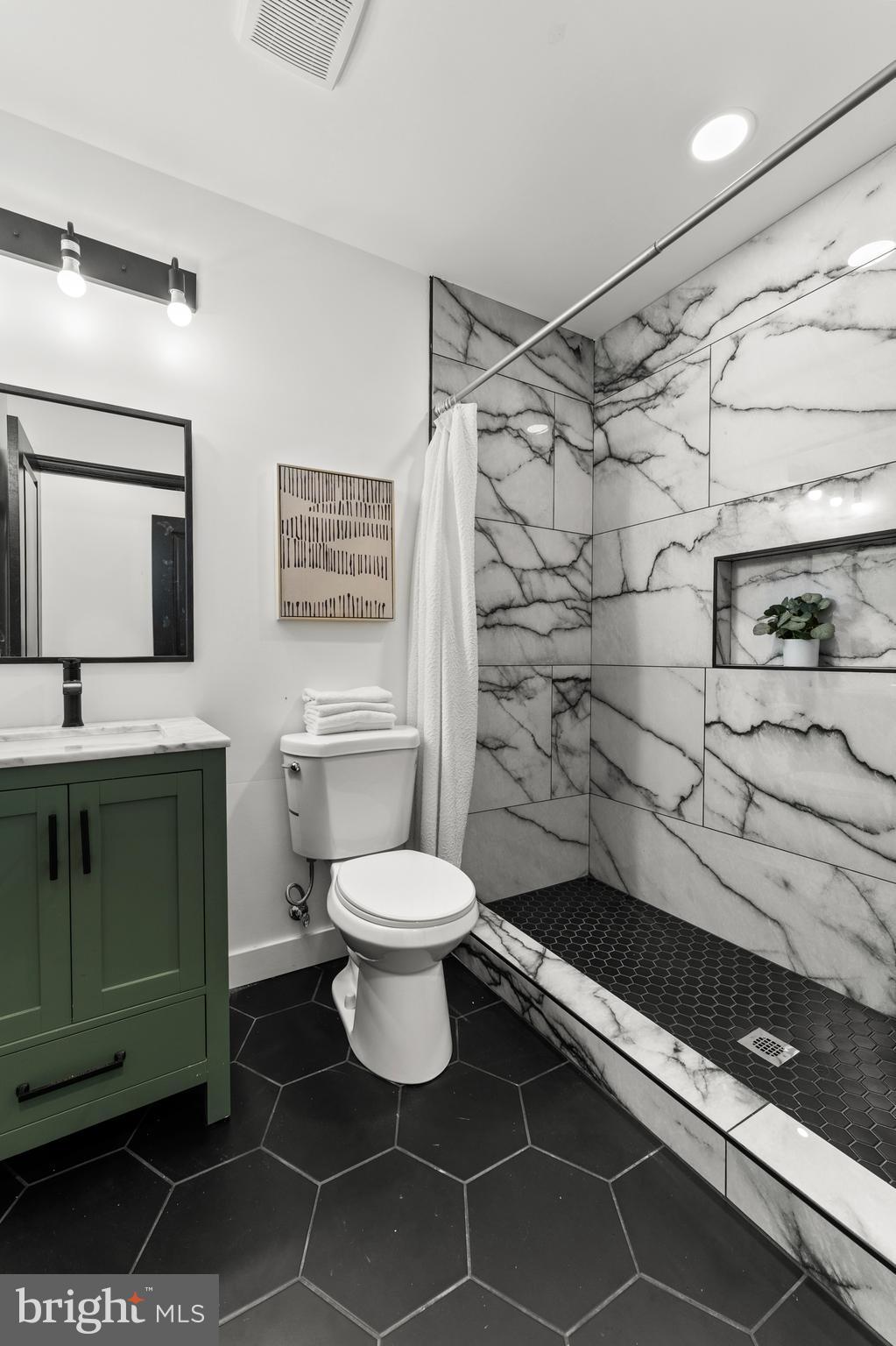 1623 Rutland Avenue Baltimore, MD 21213 - Photo 26 of 38 a bathroom with a sink toilet and shower