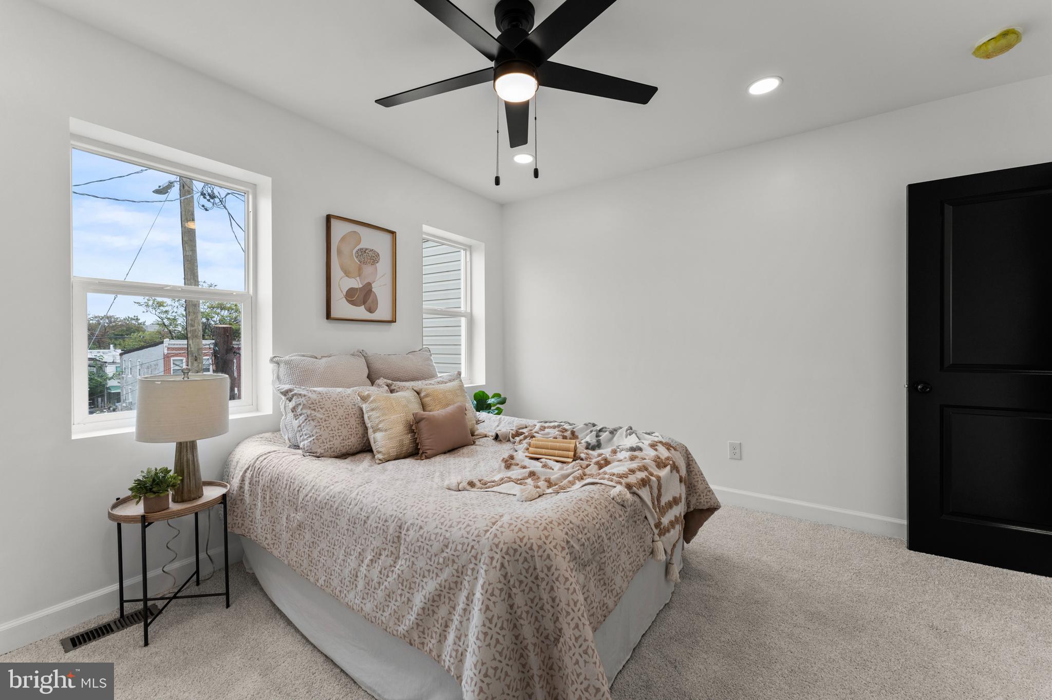 1623 Rutland Avenue Baltimore, MD 21213 - Photo 27 of 38 a bedroom with a bed and a chandelier