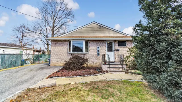 a front view of a house with a yard outdoor seating and garage