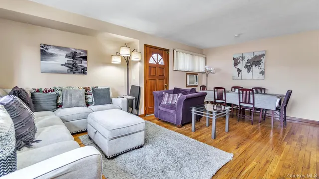 a living room with furniture wooden floor and a table