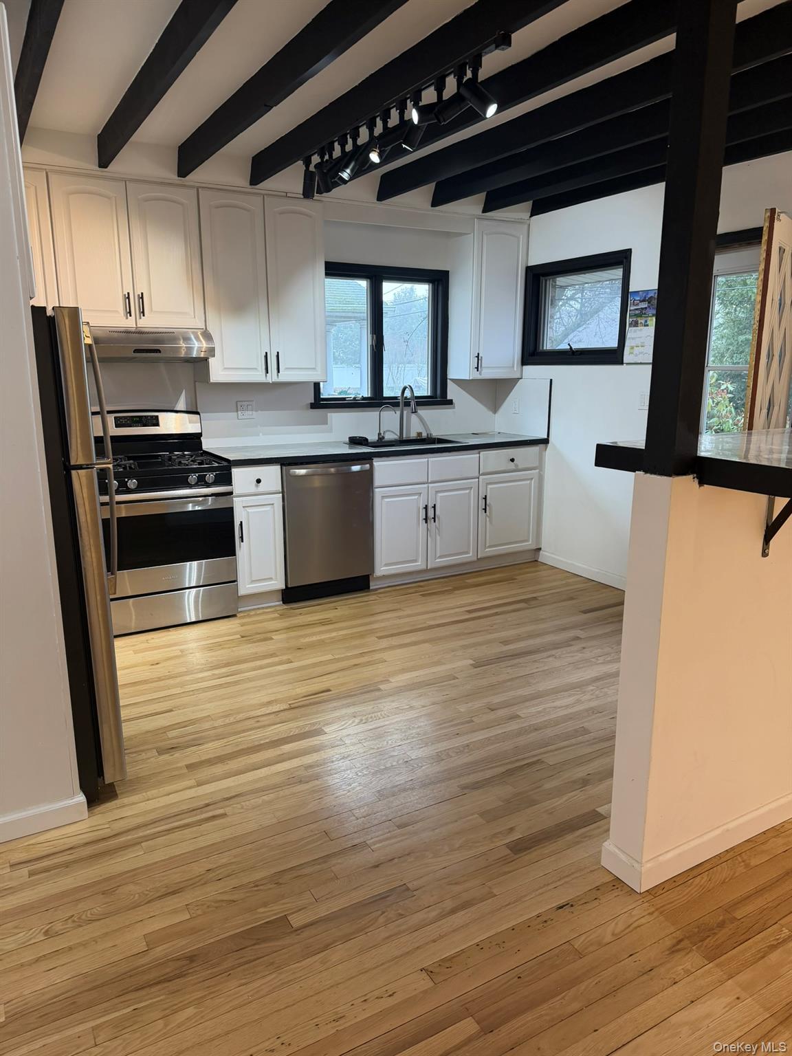 19 7th Street Bayville, NY 11709 - Photo 2 of 15 a kitchen with stainless steel appliances a refrigerator sink and cabinets