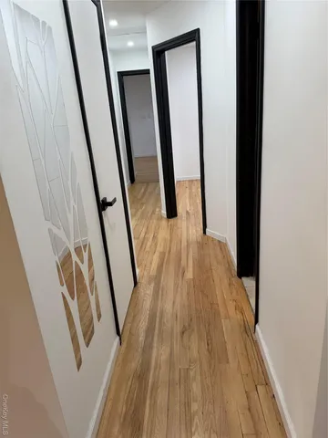 a view of an entryway with wooden floor