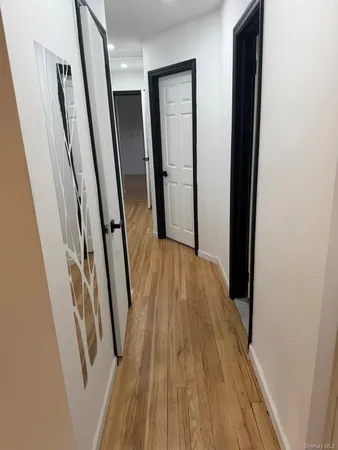 a view of hallway with wooden floor