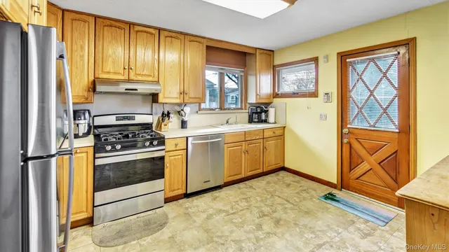 a kitchen with a refrigerator sink and cabinets