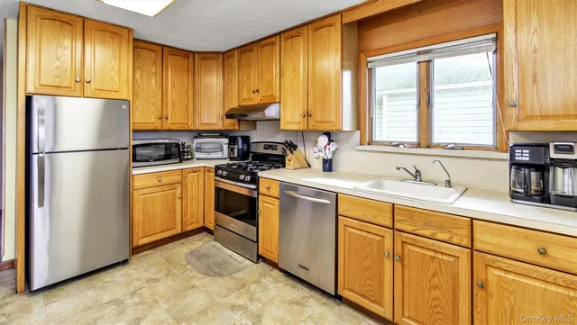 a kitchen with sink cabinets and window