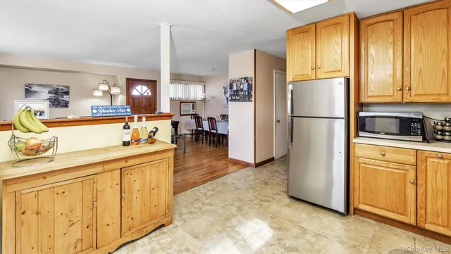 a kitchen with stainless steel appliances a refrigerator sink and cabinets