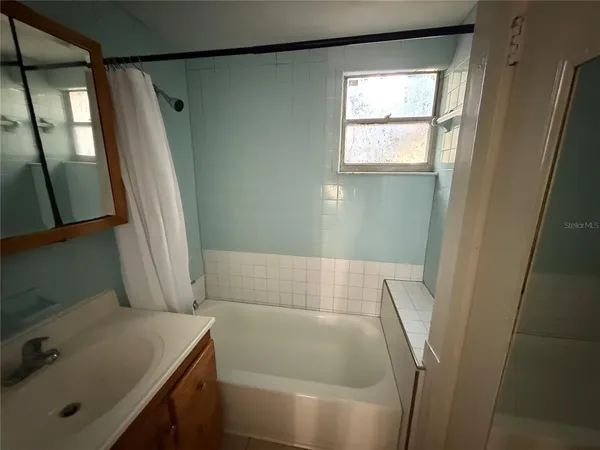 a bathroom with a tub and a sink