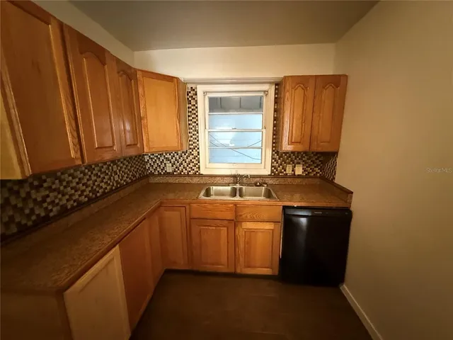 a kitchen with a sink and a refrigerator