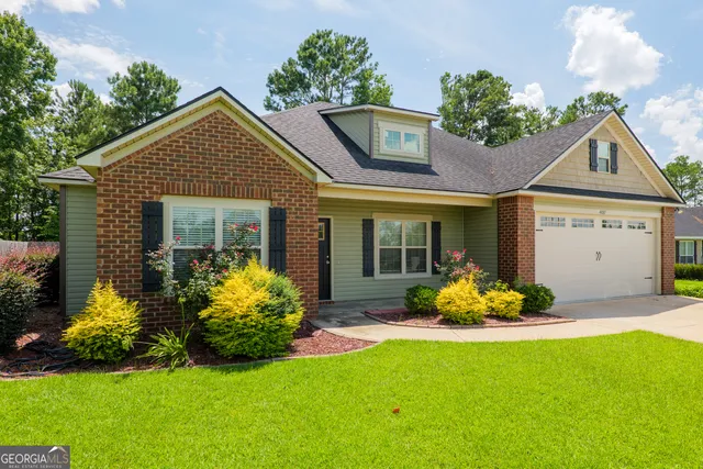 a front view of a house with a yard and garage