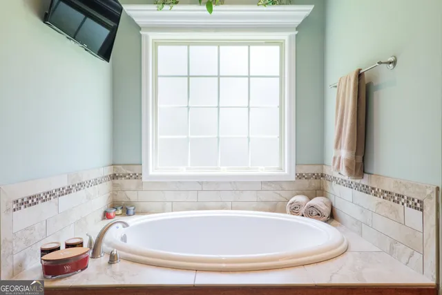 a bathroom with a bath tub and a sink