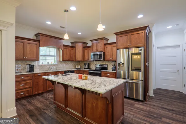 a kitchen with a refrigerator a sink and wooden cabinets