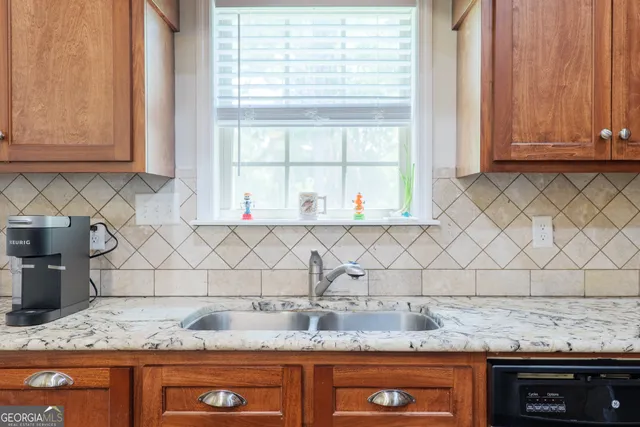 a kitchen with granite countertop a sink and a granite counter tops