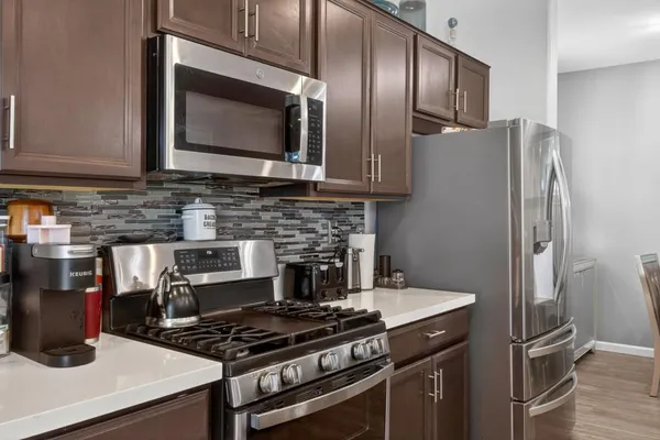 a kitchen with stainless steel appliances granite countertop a stove and a refrigerator