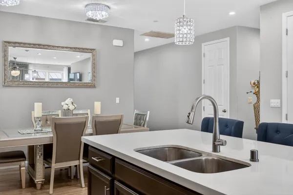 a kitchen with a sink cabinets and dining table