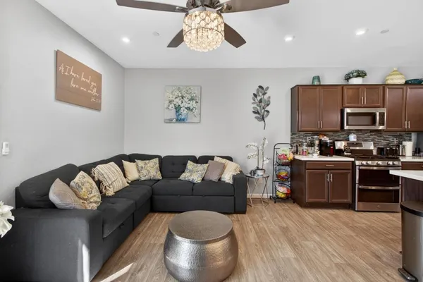 a living room with furniture and a wooden floor