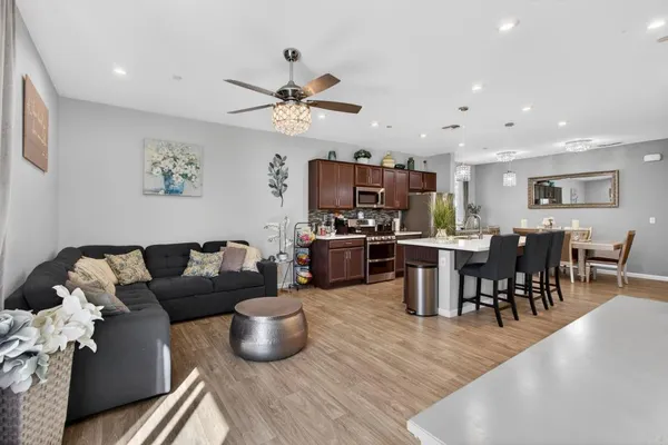 a living room with furniture kitchen view and a dining table