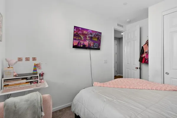 a bedroom with a bed and a flat screen tv