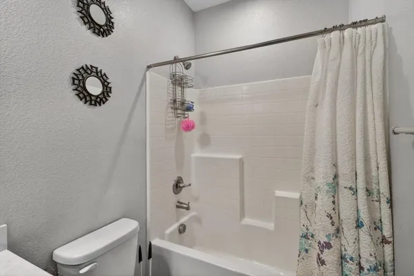 a bathroom with a bathtub and shower