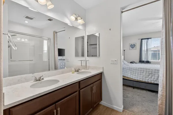 a en suite bathroom with double sink and a mirror