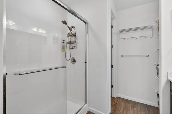 a bathroom with a glass shower door