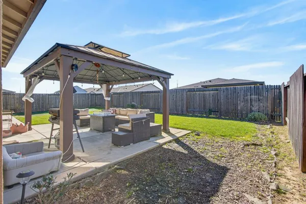 a view of a backyard with swimming pool