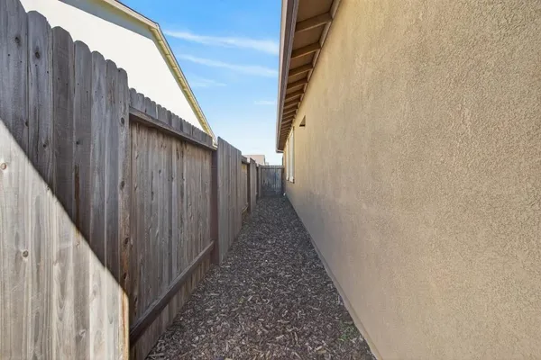 a view of a pathway of a building with wooden fence