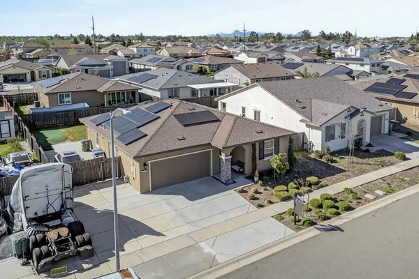 an aerial view of a houses with yard