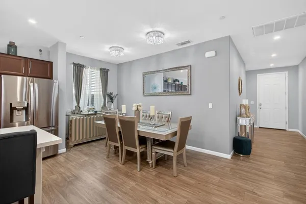 a view of a dining room with furniture and wooden floor