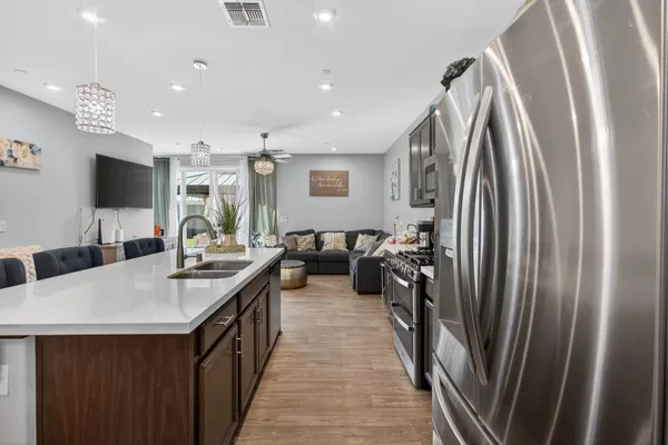 a kitchen with stainless steel appliances a sink stove and a refrigerator