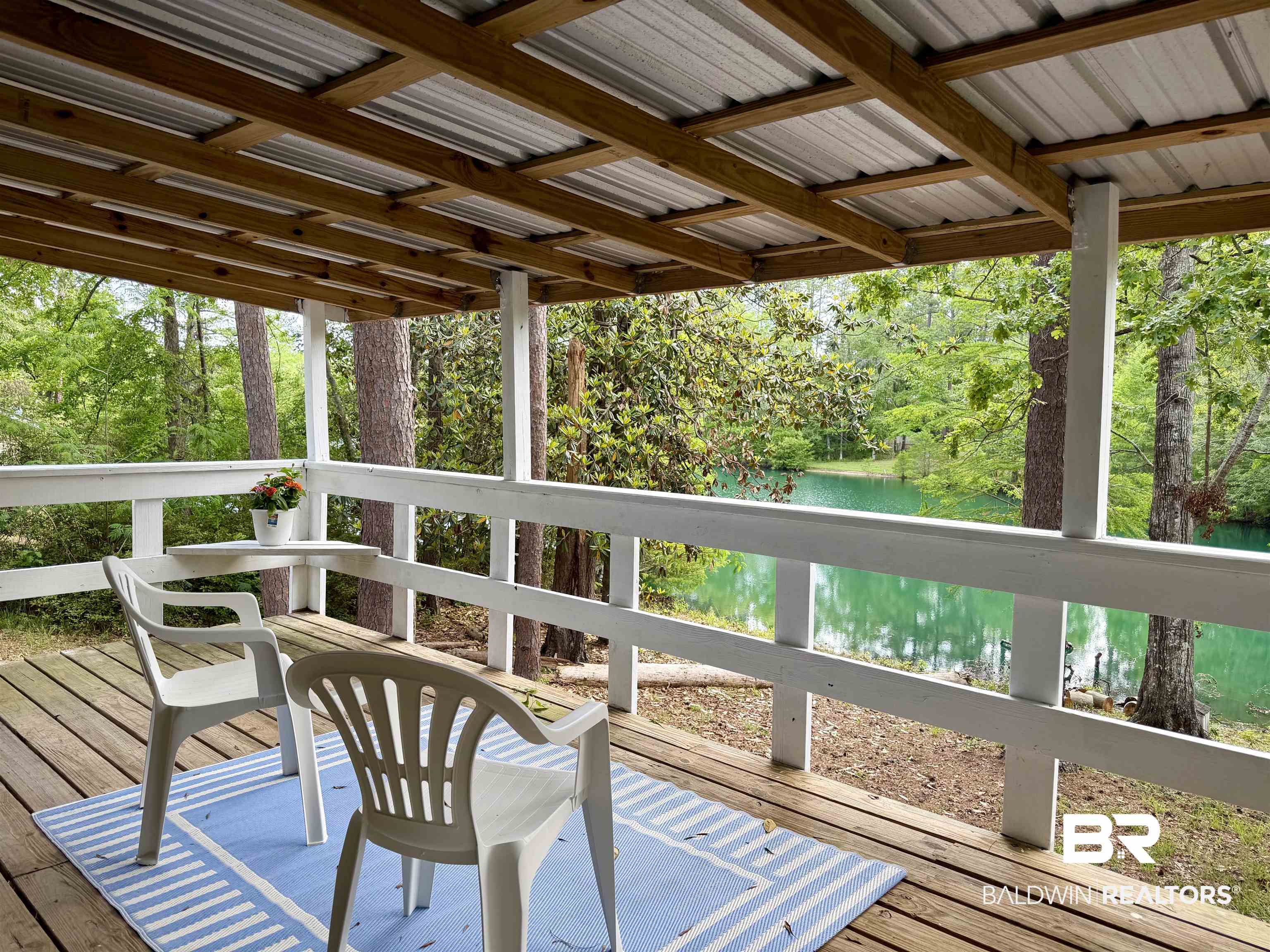 762 Buddy Lake Road Brewton, AL 36426 - Photo 17 of 20 Covered porch with exposed wood beams and a corrugated metal roof
