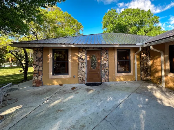 a view of a car park in front of a house