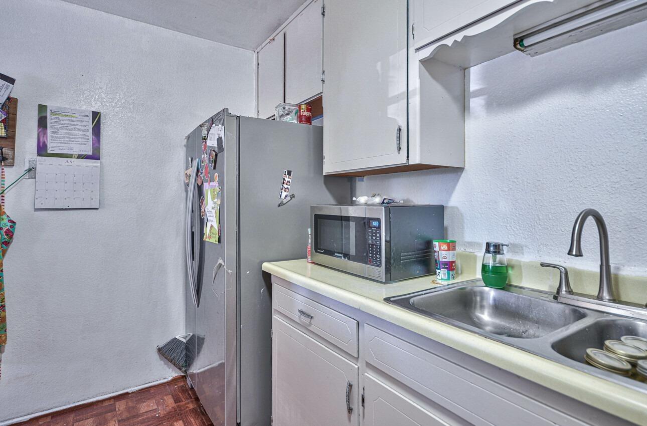 140 Inca Drive Soledad, CA 93960 - Photo 7 of 18 a kitchen with stainless steel appliances a sink a refrigerator and cabinets