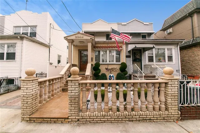 a front view of a house with white walls