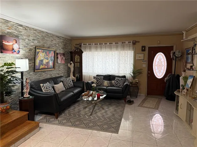 a living room with furniture and a mirror