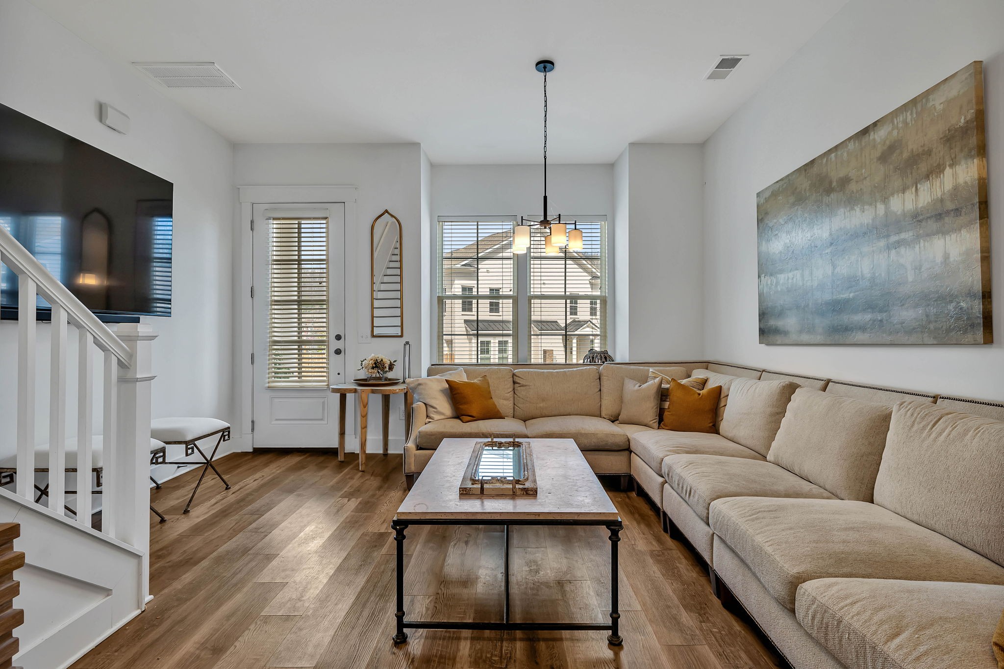 a living room with furniture and a flat screen tv