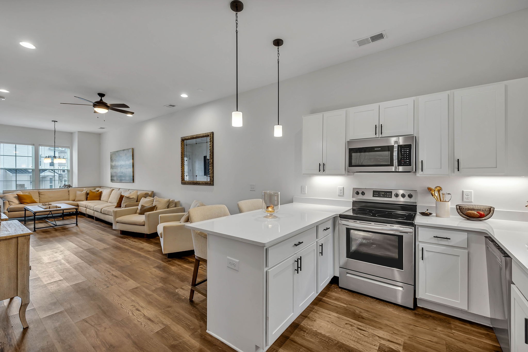 2024 Morrison Ridge Drive Nashville, TN 37221 - Photo 12 of 31 a open kitchen with stainless steel appliances kitchen island granite countertop a stove a sink dishwasher and a refrigerator with wooden floor