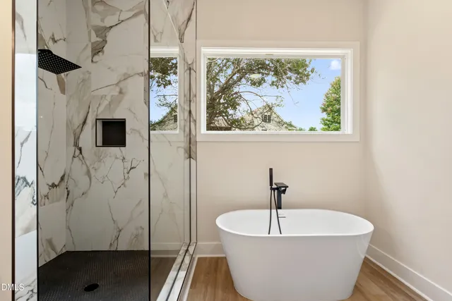 a bathroom with a sink a mirror and a shower