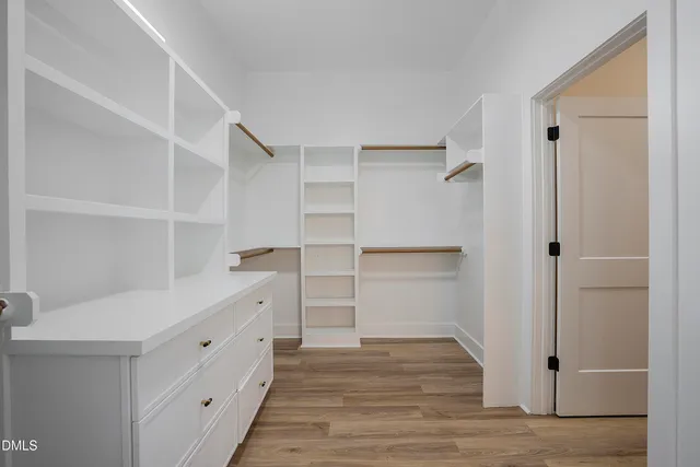 a white tub sitting next to a shower