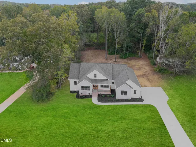a front view of a house with a yard and porch