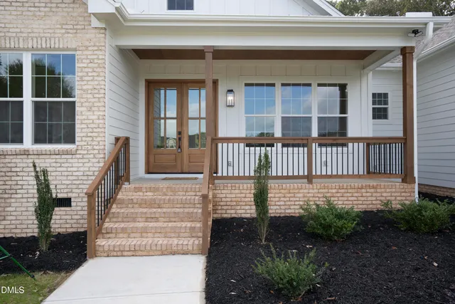 a view of a deck with a big yard and a garden