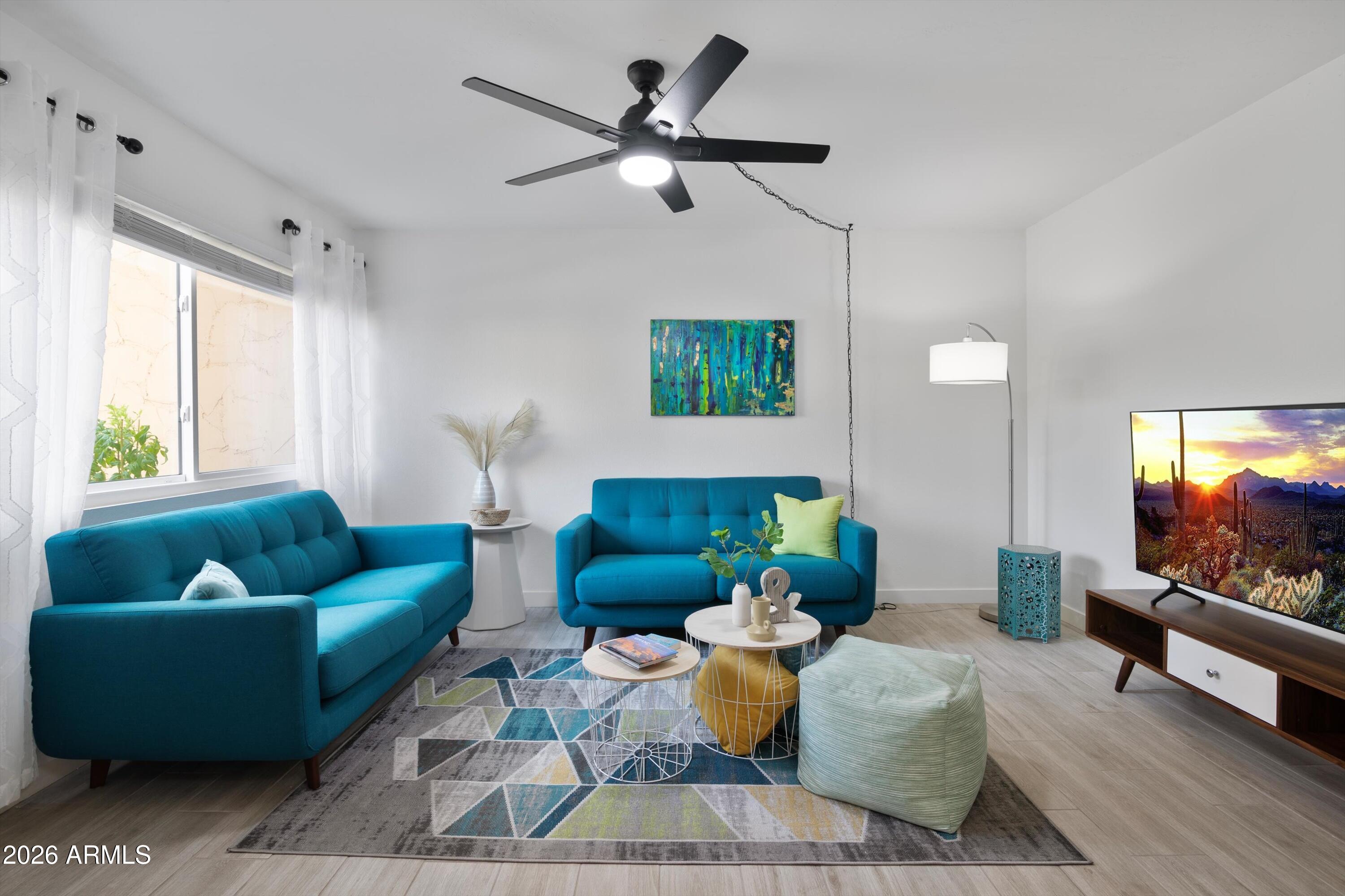 8055 East Thomas Road, Unit D105 Scottsdale, AZ 85251 - Photo 1 of 32 a living room with furniture and a flat screen tv