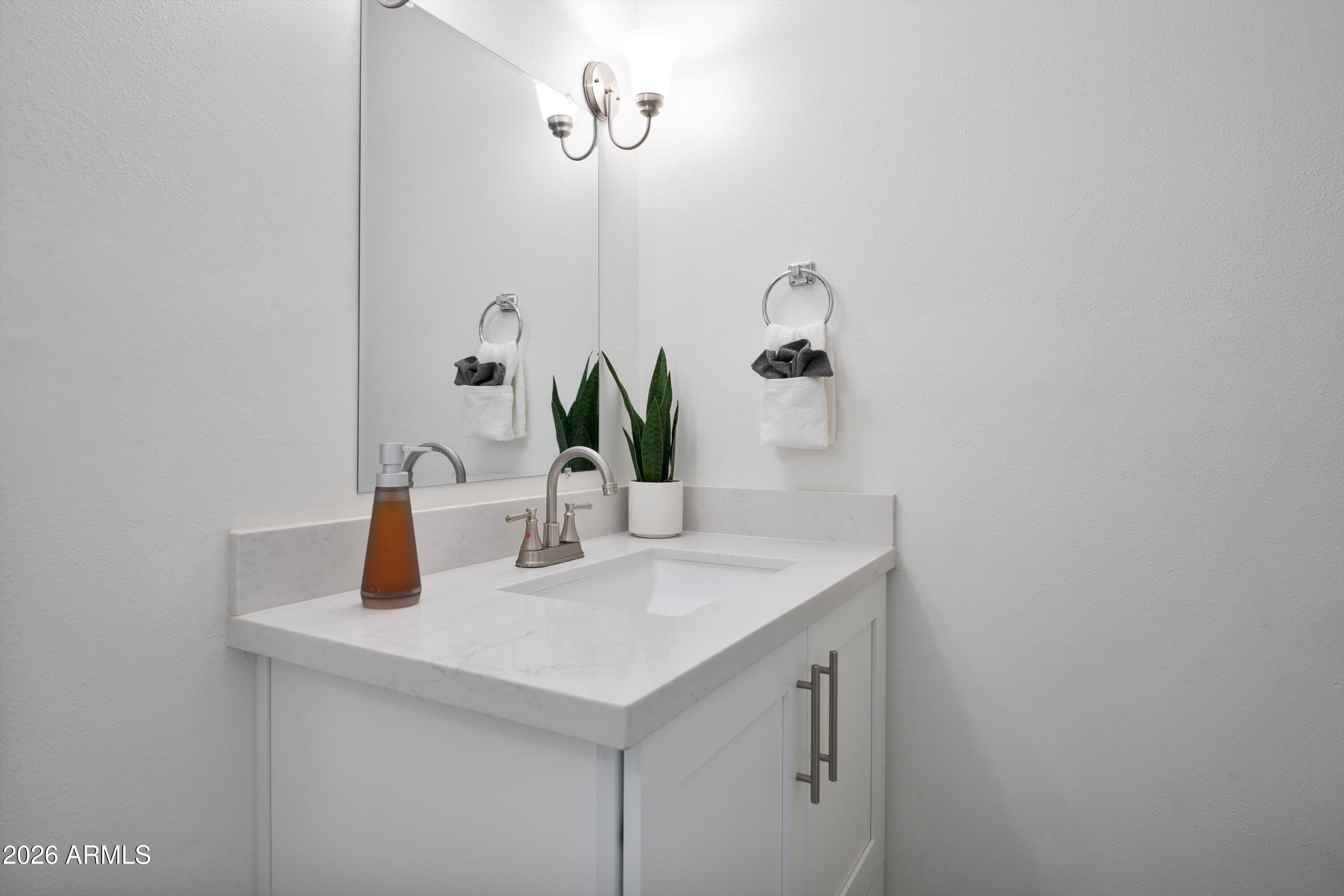 8055 East Thomas Road, Unit D105 Scottsdale, AZ 85251 - Photo 10 of 32 a bathroom with a sink and a mirror