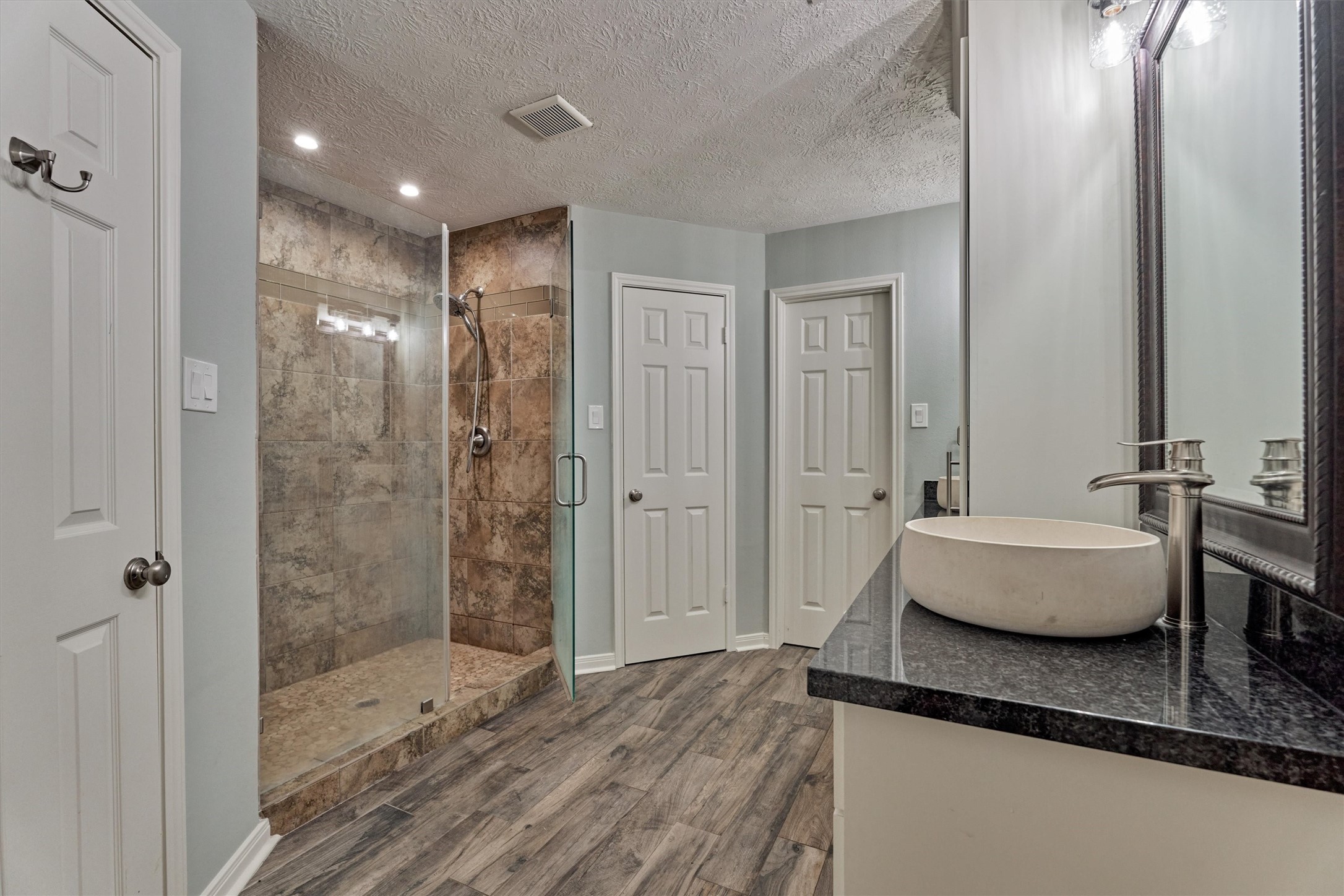 6522 Castle Pine Lane Spring, TX 77379 - Photo 13 of 49 a bathroom with a granite countertop sink a toilet a mirror and shower