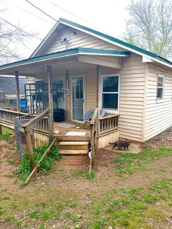 a view of a house with a yard and wooden floor