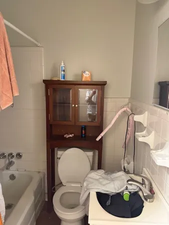 a bathroom with a toilet a sink and bathtub