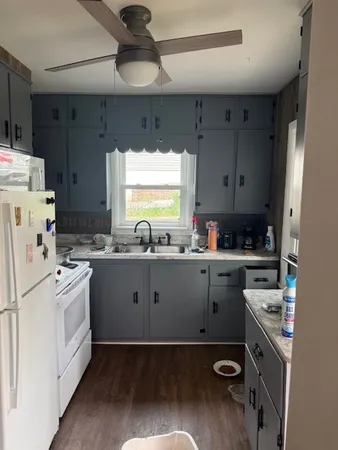 a kitchen with a stove a sink and a refrigerator