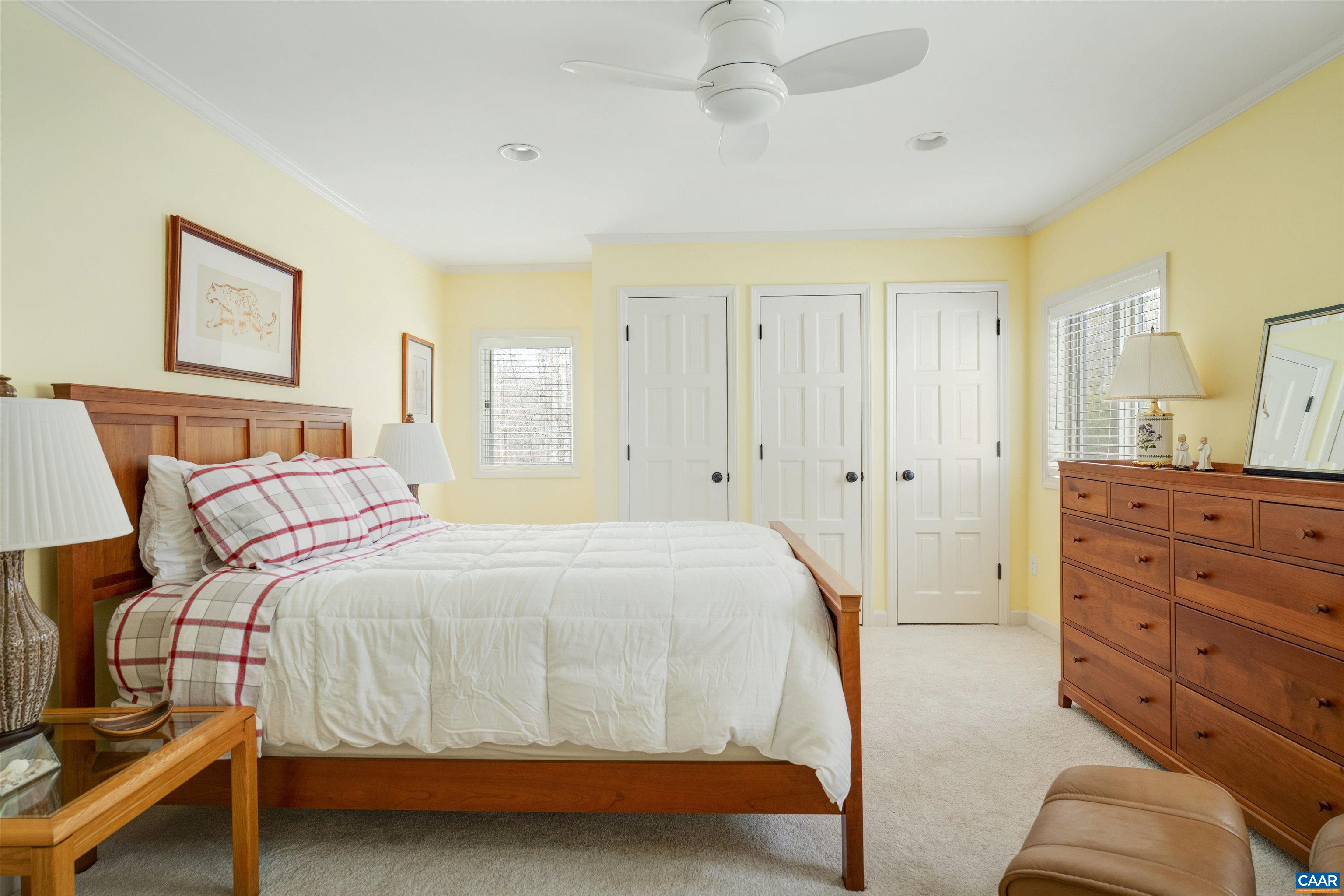 2330 Whippoorwill Road Charlottesville, VA 22901 - Photo 34 of 62 a bedroom with a bed and a chandelier
