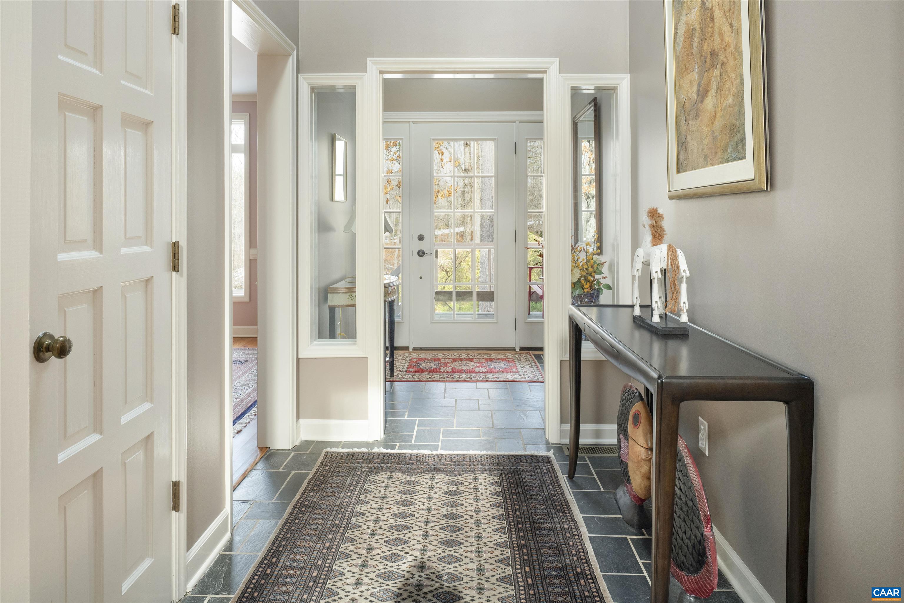 2330 Whippoorwill Road Charlottesville, VA 22901 - Photo 5 of 62 a view of a hallway with wooden floor and a living room
