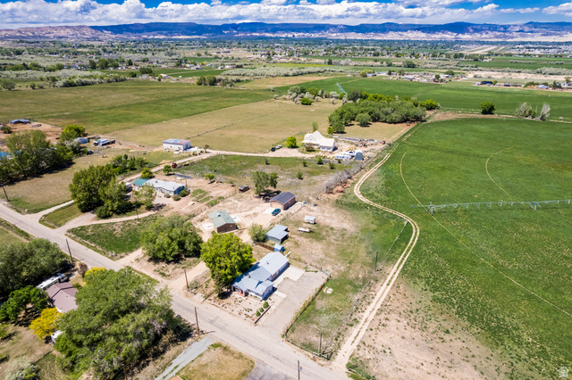1043 East 4000th Street South Vernal, UT 84078 - Photo 26 of 31 Expansive aerial capturing multiple properties amidst agricultural fields and distant mountain ranges