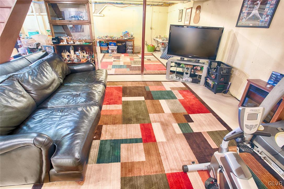 207 Bushkill Terrace Nazareth, PA 18064 - Photo 20 of 25 a living room with a rug and a flat screen tv